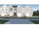 A row of new construction townhomes feature a grey color scheme and attached garages at 1109 Weavers Trace Dr, Zebulon, NC 27597