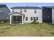 A backyard with a screened in patio, a well maintained lawn, and a black fence at 1165 Sun Spgs Rd, Wake Forest, NC 27587