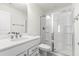 Bright bathroom featuring a white vanity with a quartz countertop and glass enclosed shower with a built in seat at 1165 Sun Spgs Rd, Wake Forest, NC 27587