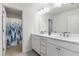 Modern bathroom featuring double sinks, quartz countertops, and a separate shower area at 1165 Sun Spgs Rd, Wake Forest, NC 27587