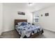 Cozy bedroom with stylish wooden bed frame and a patterned blue comforter set at 1165 Sun Spgs Rd, Wake Forest, NC 27587