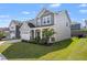 Charming two-story home with a well-manicured lawn, white garage door, and covered front porch at 1165 Sun Spgs Rd, Wake Forest, NC 27587