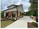 Community building with an outdoor grilling area and picnic tables, complemented by lush landscaping at 1165 Sun Spgs Rd, Wake Forest, NC 27587