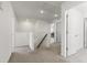 Hallway with carpet flooring, featuring multiple doors, and a visible office space at the end at 1165 Sun Spgs Rd, Wake Forest, NC 27587