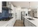Spacious kitchen with stainless steel appliances, white cabinets, and a modern range hood at 1165 Sun Spgs Rd, Wake Forest, NC 27587