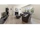 Bright living room featuring a fireplace, gray couch, coffee table, and plenty of natural light at 1165 Sun Spgs Rd, Wake Forest, NC 27587