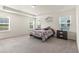 Spacious main bedroom with tray ceiling, carpet floors, multiple windows, and decorative mirrors at 1165 Sun Spgs Rd, Wake Forest, NC 27587