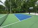 Bright, fenced pickleball court with a net, ready for recreational play and neighborhood fun at 1165 Sun Spgs Rd, Wake Forest, NC 27587