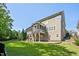 The home features a spacious fenced yard and a screened porch with stone patio at 117 Synandra Ln, Holly Springs, NC 27540