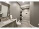 The remodeled bathroom includes a walk-in shower with a tiled surround and granite countertops at 117 Synandra Ln, Holly Springs, NC 27540