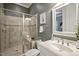 Bathroom featuring glass shower, tiled walls, and vanity sink at 117 Synandra Ln, Holly Springs, NC 27540