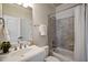 Clean bathroom showcases neutral colored tile and a shower-tub combo at 117 Synandra Ln, Holly Springs, NC 27540