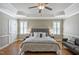 Primary bedroom features hardwood floors, tray ceiling, and lots of natural light at 117 Synandra Ln, Holly Springs, NC 27540