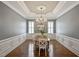 Spacious dining room with hardwood floors, a chandelier, and ample natural light at 117 Synandra Ln, Holly Springs, NC 27540