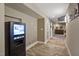 Hallway featuring a snack vending machine and access to a game area and other rooms at 117 Synandra Ln, Holly Springs, NC 27540