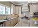 Bright kitchen featuring custom cabinets, granite counters and stainless steel appliances at 117 Synandra Ln, Holly Springs, NC 27540