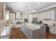 Gourmet kitchen with granite counters, stainless steel appliances, and a large center island at 117 Synandra Ln, Holly Springs, NC 27540