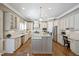 Bright kitchen featuring custom cabinets, granite counters, stainless steel appliances and hardwood floors at 117 Synandra Ln, Holly Springs, NC 27540