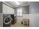 Laundry room with modern washer and dryer and a utility sink at 117 Synandra Ln, Holly Springs, NC 27540