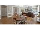 Open-concept living and dining area with hardwood floors, archways, and a view of the fireplace at 117 Synandra Ln, Holly Springs, NC 27540