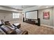 Large entertaining room features movie screen, recessed lights, and tiered seating at 117 Synandra Ln, Holly Springs, NC 27540