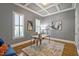 Well-lit home office featuring hardwood floors, coffered ceiling, and neutral decor at 117 Synandra Ln, Holly Springs, NC 27540