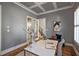 Stylish home office features a modern desk, and a bench near French doors at 117 Synandra Ln, Holly Springs, NC 27540
