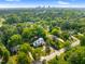 Distant aerial view of neighborhood, house, mature trees and city skyline at 125 Lord Ashley Rd, Raleigh, NC 27610