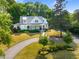 Stunning home with beautiful landscaping, circular driveway and charming exterior elevation at 125 Lord Ashley Rd, Raleigh, NC 27610