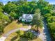 An aerial view of a manicured lawn with circular driveway leading to a stunning craftsman style house at 125 Lord Ashley Rd, Raleigh, NC 27610