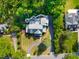Aerial view of house, driveway, landscaped yard and backyard firepit at 125 Lord Ashley Rd, Raleigh, NC 27610