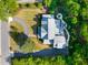 Birds-eye view of lush property featuring a circular driveway and backyard fire pit area at 125 Lord Ashley Rd, Raleigh, NC 27610