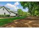 Green backyard featuring a patio with outdoor seating, dining table, and manicured landscaping at 125 Lord Ashley Rd, Raleigh, NC 27610