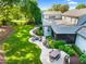 Aerial view of backyard patio featuring a fire pit, seating, dining table, and manicured landscaping at 125 Lord Ashley Rd, Raleigh, NC 27610