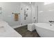 Luxurious bathroom with modern fixtures, a soaking tub, and a glass-enclosed shower at 125 Lord Ashley Rd, Raleigh, NC 27610
