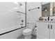 Modern bathroom featuring white tile, glass shower doors, and sleek fixtures at 125 Lord Ashley Rd, Raleigh, NC 27610