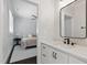 Bathroom view from the bedroom featuring a modern vanity, quartz countertop, and sleek black fixtures at 125 Lord Ashley Rd, Raleigh, NC 27610