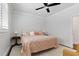 Bedroom with neutral walls, ceiling fan, and patterned bedding at 125 Lord Ashley Rd, Raleigh, NC 27610