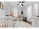 Cozy Bedroom featuring a comfortable chair and a view of the ensuite bath at 125 Lord Ashley Rd, Raleigh, NC 27610