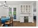 Bright dining area features a blue table and access to outdoor living area at 125 Lord Ashley Rd, Raleigh, NC 27610