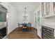 Bright dining area features a blue table, wood floors, and a beverage fridge at 125 Lord Ashley Rd, Raleigh, NC 27610