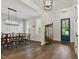 Dining room with hardwood floors, modern light fixture, and custom paneling at 125 Lord Ashley Rd, Raleigh, NC 27610