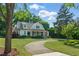 Beautifully landscaped home with mature trees and inviting circular driveway at 125 Lord Ashley Rd, Raleigh, NC 27610