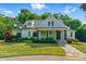 Charming single-Gathering home with a well-manicured lawn and stone pathway leading to the front porch at 125 Lord Ashley Rd, Raleigh, NC 27610
