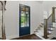 Inviting foyer with a blue front door, staircase, and natural light at 125 Lord Ashley Rd, Raleigh, NC 27610