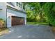 Garage with a well-maintained driveway and lush landscaping at 125 Lord Ashley Rd, Raleigh, NC 27610