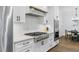 Kitchen featuring gas range, stainless steel appliances, and white cabinets at 125 Lord Ashley Rd, Raleigh, NC 27610