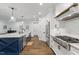 Modern kitchen features a large island, stainless appliances and beautiful wood floors at 125 Lord Ashley Rd, Raleigh, NC 27610