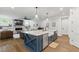 Island with stainless appliances, farm sink with seating and fireplace in background at 125 Lord Ashley Rd, Raleigh, NC 27610