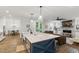 Modern kitchen with large island and open layout to the living room at 125 Lord Ashley Rd, Raleigh, NC 27610